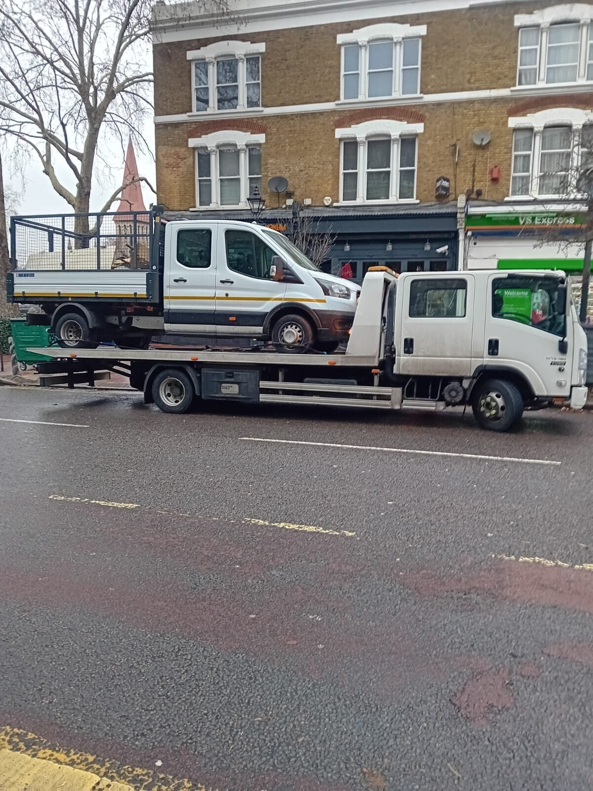 A Transit tipper loaded on our recovery truck in London